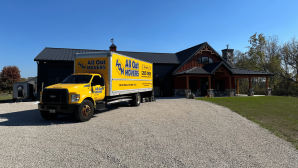 All Out Movers Truck in front of ranch style home
